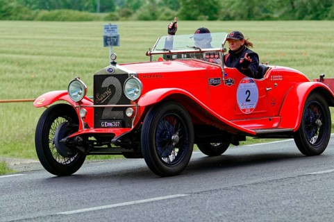 Red vintage car with a smiling woman on a rural road, vintage car, car race, Mille Miglia, 1000