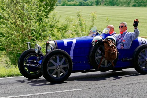 Blue classic car with two men on a country road under a sunny sky, classic car, car race, Mille