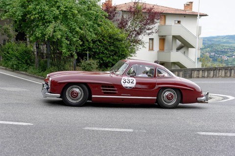 No. 332, Mercedes-Benz 300 SL W 198, model year 1955, Red classic car in a bend in front of a house