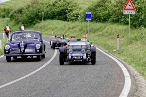 Purple vintage car and black car driving side by side on country road, vintage car, car race, Mille