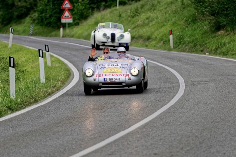 Classic car with two people on a winding country road, classic car, car race, Mille Miglia, 1000