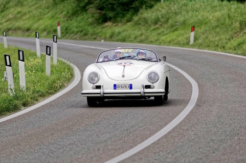 White Porsche vintage convertible on a winding country road, classic car, car racing, Mille Miglia,