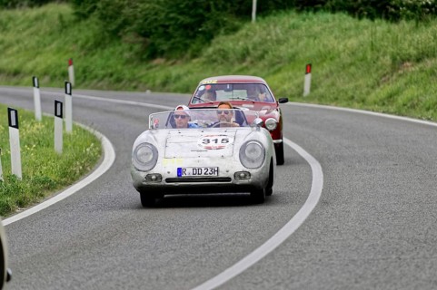 Open-top classic car followed by another car on a country road, classic car, car race, Mille