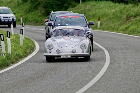 Silver classic car leads a group of cars on the road, classic car, car race, Mille Miglia, 1000