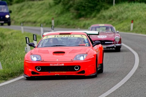 A red Ferrari racing car drives dynamically in front of a classic car, classic car, car race, Mille