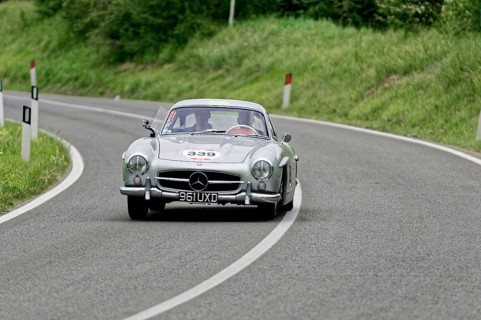 A silver Mercedes classic car drives through a bend, classic car, car race, Mille Miglia, 1000