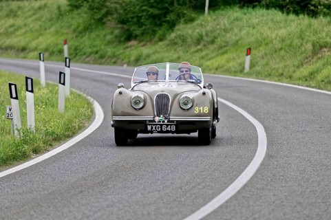 Classic vintage car with two occupants on a country road, vintage car, car race, Mille Miglia, 1000