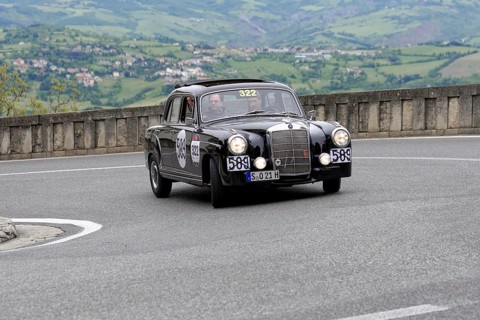 No. 322, Mercedes-Benz 220A, model year 1955, black vintage car driving on a winding road through a