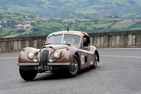 No. 236, Jaguar XK 120 Coupé, built in 1952, Brown vintage car on winding road with picturesque