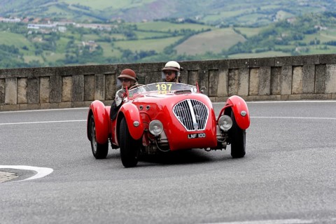 No.197, Healey 2400 Silverstone, built in 1950, red car with two occupants in classic helmets on a