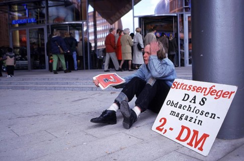 Berlin, DEU, 18.10.1998 -- Chris, seller of a homeless magazine Straßenfeger, sits in front of the