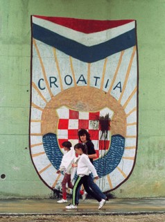 HRV, Split, 01.10.1991 -- Passers-by walk past the Croatian national coat of arms at an underpass