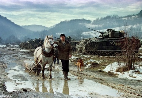 BIH, Tuzla, 01.01.1996 -- A Bosnian farmer pulls his horse past the base camp of American IFOR