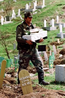BIH, Bosnia, Tuzla, 07.05.1993 A Bosnian soldier is burying a child's coffin. The toddler was