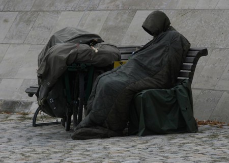 DEU Germany Germany Berlin A homeless person sits on the banks of the Spree opposite the Federal