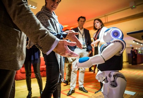 ITA Italy Castelfalfi participants greet a robot during a conference for tourism managers