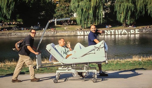 DEU Germany Germany Berlin Two men drive their friend on a hospital bed along the Landwehr Canal