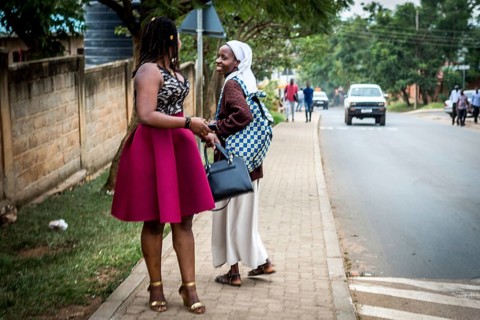 RWA RWANDA Rwanda Kigali Two woman, one in purple smell and a novice, meet on the street