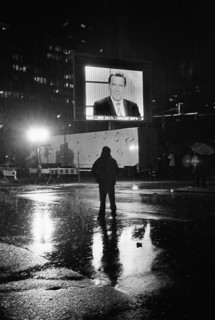 DEU, Germany, Berlin, 22.09.2002, Man in the rain watching Gerhard Schröder on a large screen