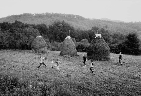 BIH, Bosnia, Tuzla, 05.10.2005, children playing soccer next to haystacks