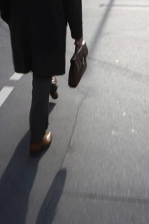 Man with briefcase crosses pedestrian traffic light in Friedrichsstraße