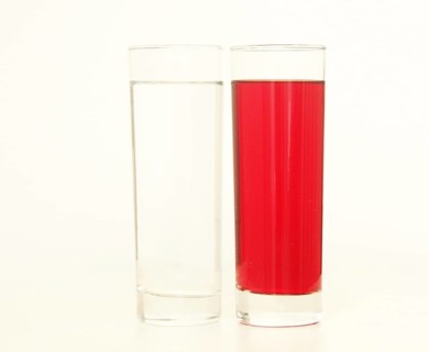 Two glasses of red and transparent liquid on white background, São Paulo, Brazil