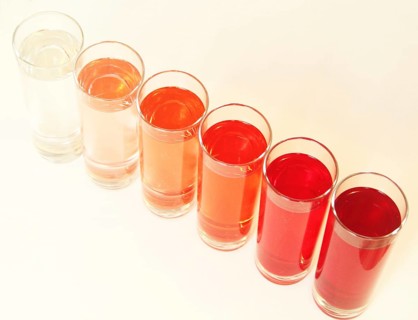 Five glasses of red liquid on white background, São Paulo, Brazil