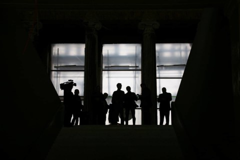 Media representatives wait at the end of the entrance steps at the start of the press tour in front