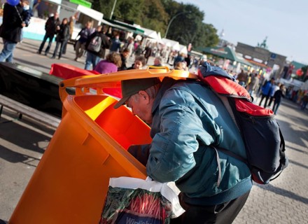DEU Germany Berlin A collector checks the garbage cans for recyclable materials. Scene on the eve