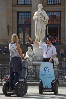GERMANY Berlin Segway drivers during a guided city tour in front of the Schiller Monument on the