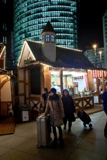 Berlin 2010-11-24 tourists with suitcases at the Christmas market at Potsdamer Platz DEU Berlin