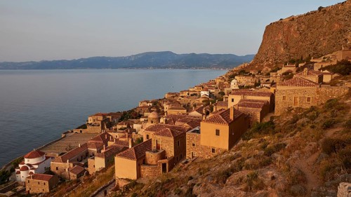 Soft morning light, medieval coastal town at sunrise with sea view and tiled roofs, Monemvasia,