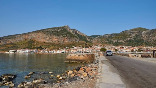 Road leads along the coast of a town against a mountainous backdrop, Monemvasia, Monemvassia,