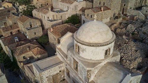 Drone view, historic church with dome surrounded by a village, taken from the air, Monemvasia,