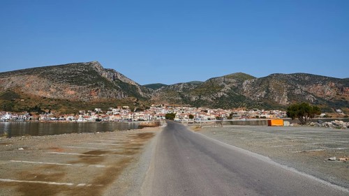 Paved road leads to a seaside town with mountains in the background, Monemvasia, Monemvassia,