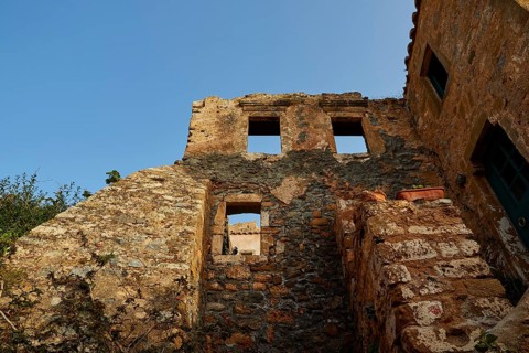 Soft morning light, the remains of an old stone building, window openings, blue sky, dilapidated,