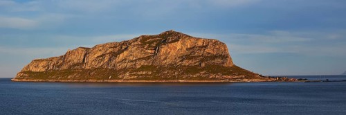 Rocky island in calm water at sunset with blue sky, Monemvasia, Monemvassia, Malvasy, Byzantine