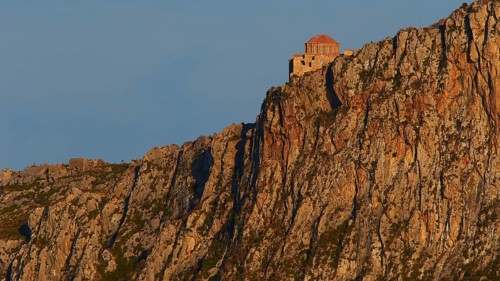 Orhodox church of Hagia Sophia, secluded monastery buildings on rough rocks, illuminated by the