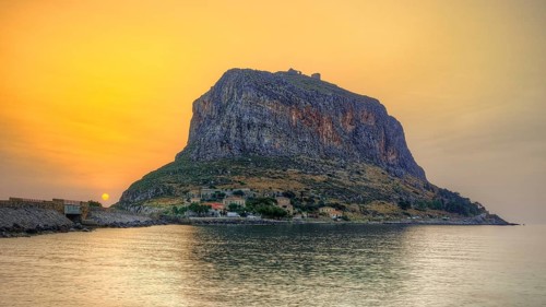 HDR, impressive seaside rock in warm sunrise light, calm water surface, Monemvasia, Monemvassia,