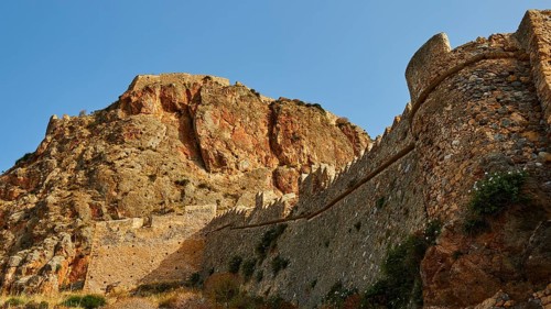 Mighty old city wall wraps around a dramatic rocky landscape, Monemvasia, Monemvassia, Malvasy,