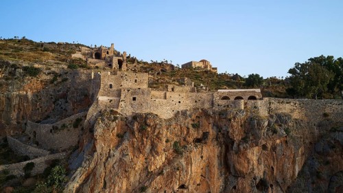 Mighty castle perched over rocky landscape under clear sky, Monemvasia, Monemvassia, Malvasy,