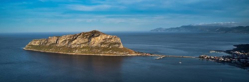 Drone shot, island connected to the mainland by bridge, surrounded by blue water, Monemvasia,