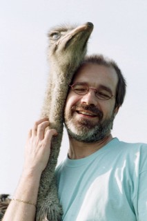 DEU, Mannheim, 22.07.1994 -- ostrich breeder (man, hug, bird ostrich, stroking, affection) -- Â©