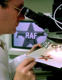 DEU, Wiesbaden, 01.09.1994 -- A BKA official examining an RAF letter for authenticity. -- A police