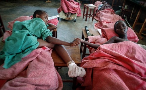 RWA Rwanda Kigali Injured Tutsi refugee children receive medical care in a makeshift hospital by