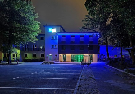 Blue-illuminated Berlin City Mission at night, Berlin, Germany
