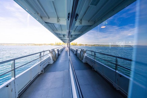 Boat trip with window reflection showing the sea on a sunny day, boat trip, Lake Constance, Germany