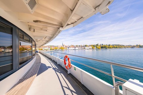 View from the ferry of a coastal town with clear sky, boat trip, Lake Constance, Germany