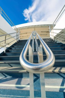 Modern metal staircase on a boat with a view of the blue sky, boat trip, Lake Constance, Germany