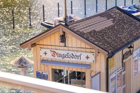 Close-up of a building at a pier in sunlight, boat trip, Lake Constance, Germany